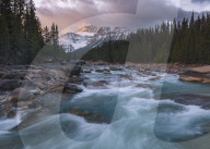 Sunrise and glacial blue rushing waters at Mistaya Canyon, Banff National Park, Alberta, Canada