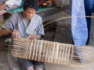 Man making a fish trap, village home near Siem Reap, Cambodia, Southeast Asia