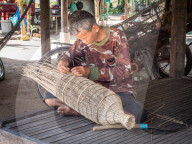 Man making a fish trap, village home near Siem Reap, Cambodia, Southeast Asia