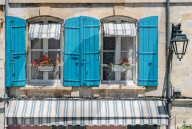 Traditional Provencal building facade in the historic centre of Arles, a city on the Rhone River in Provence, France