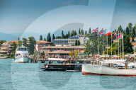 Busy marina and ferry terminal at Sirmione, Lombardy, Italy on a summer day