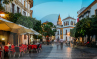 Pedestrian street in the historic centre of Cordoba, Andalucia, Spain with Bell Tower - La Mezquita / Great Mosque in background