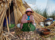 Native Uro Lady cooking, Uros Floating Islands, Lake Titicaca, Puno Region, Peru