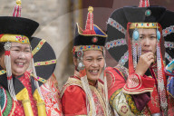 Three women wearing traditional Mongolian costumes. Harhorin, South Hangay province, Mongolia.