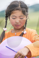 Portrait of a Mongolian Nomadic girl with braids. North Hangay province, Mongolia.