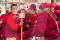 Tibetan Buddhist nun and prayer wheel, Boudhanath Stupa, Kathmandu, Nepal