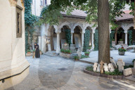 A nun sweeps the grounds of the Stavropoleos Monastery Church (Biserica MÄƒnÄƒstirii Stavropoleos) early in the morning.