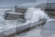 Waves crashing into the sea wall at Scarborough, North Yorkshire, UK