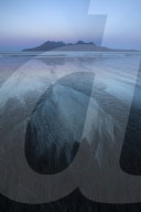 The Isle of Rum from Singing Sands on the Isle of Eigg, Small Isles, Inner Hebrides, Scottish Highlands, Scotland, UK