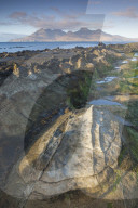 The Isle of Rum from Singing Sands on the Isle of Eigg, Small Isles, Inner Hebrides, Scottish Highlands, Scotland, UK