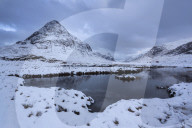 View to a snow covered Buachaille Etive Beag from Lochan na fola close to the A82 through Glencoe Lochaber Highlands Scotland