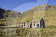 Ruined farmhouse beneath the rocky escarpment of Benbulbin, County Sligo, Republic of Ireland