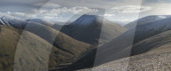 View down Bowderdale to the snow capped peaks of Yarlside and Cautley Crag, Howgill Fells near Sedbergh, Cumbria, UK