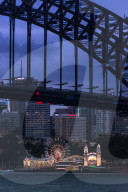 Sydney Harbour brdge with Luna Park amusement park on North shore. Sydney, New South Wales, Australia