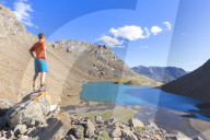 A boy watched Lai da Fasch'Alba from above. Val Tasna, Engadin Valley, GraubÃ¼nden, Switzerland, Europe.