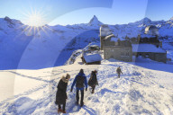 Tourists walks in the snow near the astronomical observatory of Gornergrat, Zermatt, Canton of Valais / Wallis, Switzerland.