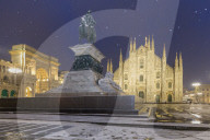 Monument of Napoleon in Piazza Duomo during a snowfall at twilight. Milan, Lombardy, Northern Italy, Italy.