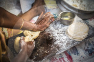 Portrait of an Indian woman making chapati in Fort Kochi (Cochin), Kerala, India