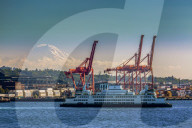 Ferry crossing Elliott Bay with Mount Rainier and the harbour in the background. Seattle, Washington, USA