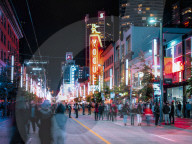 People having fun on Friday night on Granville Street, Orpheum Theatre visible in the back. Vancouver, Canada, North America