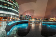 View of London skyline and Tower of London visible in background at night, Southwark, London, England, United Kingdom, Europe