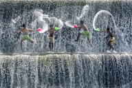 Boys water fight, Tukad Unda dam, Bali, Indonesia, South East Asia.