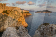 View to Lovrijenac Fortress, the city walls and Lokrum Island at sunset