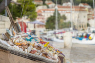 Boxes full of sea shells and sea stars for sale at the port of Hvar Town