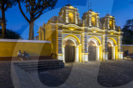 Illuminated entrance gate of the chapel El Calvario near Antigua at dusk