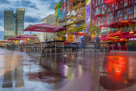 Refletcions of the Dancing Towers (Tanzende Tuerme) and the illuminated buildings at the Spielbudenplatz on the wet ground
