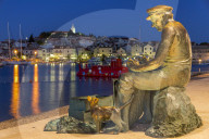 Fisherman statue with view to the old town of Primosten in the background