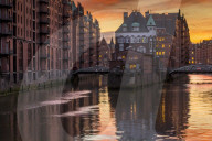 Wasserschloss building at the historical warehouse complex (called Speicherstadt) seen from Poggenmuehlenbruecke during sunset