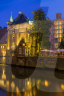 Illuminated WasserschlÃ¶sschen building in the historical Speicherstadt (Warehouse complex) of Hamburg at dusk