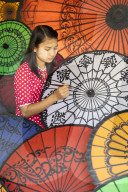 Young lady decorates colourful parasols in Bagan, Myanmar (Burma)