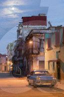 A blue vintage American car parked on a street in the early morning in Havana, Cuba, West Indies, Caribbean, Central America