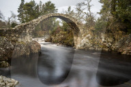The old packhorse bridge built in 1717 over the River Dulnain in the village of Carrbridge near Aviemore in the Cairngorms