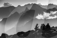 A group of trekkers relaxing after a long day at New Shira Camp on the Machame Route. In the background is the Shira Ridge.