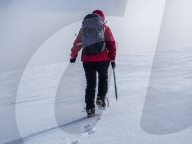 A female Mountaineer crossing the snow fields in the Cairngorm National Park in Winter