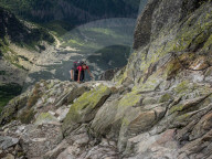 Lady scrambling on Swinica, 2301m, on the Polish/Slovak border in the Tatra mountains assisted by metal chains in some sections