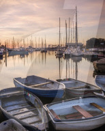 Early morning light upon the tenders, yachts and fishing boats at the Quay, Lymington, Hampshire, UK.
