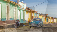 A classic car in a colourful colonial street in Trinidad, Cuba, Caribbean, Central America.
