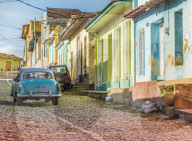A car in a colourful colonial street in Trinidad, Cuba, Caribbean, Central America.