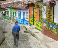 A typically colourful street with buildings covered in traditional local tiles in the picturesque town of Guatape in Colombia.