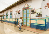 A typically colourful street with buildings covered in traditional local tiles in the picturesque town of Guatape in Colombia.