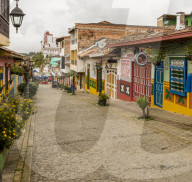 A typically colourful street with buildings covered in traditional local tiles in the picturesque town of Guatape in Colombia.