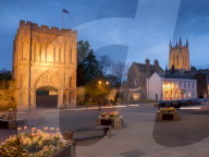 Norman gatehouse tower and Abbey at twilight