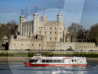 UK, England, London, Tower of London across Thames with tour boat