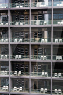 Uniform and soulless apartment blocks with two empty white chairs on each balcony, Manila, Philippines