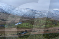 Farmhouse in a wintry landscape in the Snowdonia National Park, Gwynydd, Wales, UK.