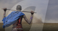 Masai Man watching wind storm in Amboseli National Park, Kenya.